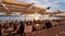 Crowds of people meet the sunset at the seafront terrace of Savannah cafe