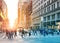 Crowds of people walking across the busy intersection in Midtown Manhattan, New York City