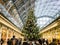 Crowds swirl around Christmas tree, St Pancras Station, London, UK