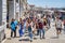 Crowds of tourists strolling on the cobblestone alley near Grand Canal in Venice