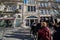 Crowds of tourists wait outside in line to visit the famous bookstore of Livraria Lello in