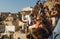 Crowds of tourists waiting for sunset at the castle and village of Oia, Santorini, Greece