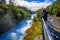 A crown of people over the bridge enjoying the view of the powerful Huka Falls on the Waikato River near Taupo North