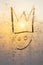 Crown and smile icon king symbol, imitation of a king smile, golden background with frosty stack texture, vertical frame for