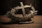 The crown of thorns of Jesus with cross on old wood background. Easter concept.