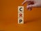 CRP - C-Reactive Protein Test symbol. Wooden cubes with word CRP. Doctor hand. Beautiful orange background. Medical and C-Reactive