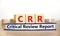 CRR critical review report symbol. Concept words CRR critical review report on wooden cubes on book on a beautiful white