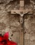 Crucifix in brown tones with red lily and rock