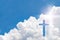 Crucifix cross on beautiful sky with sunbeam. Holy cross of Jesus christ on clouds background