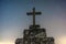 crucifix in the foreground and  night sky with stars.