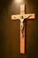 Crucifix with light shining on it isolated on brown mottled background