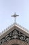 Crucifix on roof architecture of the church on clear day.