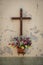 crucifix on wall with flowers - Jesus sculpture on cross on vintage background