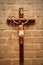 Crucifix on wall in spotlight. Jesus Christ on cross.