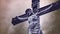 Crucifixion cross with Jesus Christ statue over stormy clouds and Snow falling time lapse