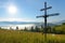 Crucifixion of Jesus Christ in the midst of meadows in Carpathian mountains with the sun in the sky