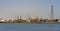 Crude oil refinery plant and many chimney with petrochemical tanker or cargo ship at coast of river on sky afternoon  bright day