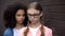 Cruel black student bullying caucasian schoolgirl eyeglasses, emotional pressure