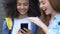 Cruel schoolgirls mocking friend in social networks using phone, cyberbullying