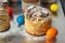 Cruffin as Easter cake decorated with raisins, dried apricots and sugar powder on kitchen table among easter eggs