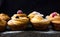 Cruffin - Buns from yeast dough. Dark background. Mystical light. cinnamon craffin cinnabon mix of croissant and muffin