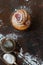 Cruffin with raspberry filling on a dark table