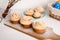 Cruffins easter spring pastries, a mixture of muffin and croissant on a light background, the composition Easter painted eggs