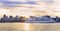 Cruise boat sailing at sunset on St. Lawrence River with skyline of Montreal on the background