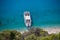 Cruise boat seen from above on clear blue water