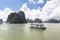 Cruise boats sailing among the karst formations in Halong Bay, Vietnam, in the gulf of Tonkin.