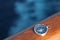 Cruise compass on wooden rail sea