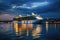 Cruise liner docked at city waterfront at night