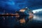 Cruise liner docked at city waterfront at night