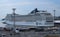 Cruise liner in the port of Helsinki. At the pier, a line of trucks for loading on a ferry