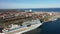 The cruise ship `AIDA diva` of AIDA Cruises has moored at the Cruise Ship Terminal - pan left with view of city of Warnemuende