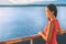 Cruise ship Alaska travel vacation woman on luxury boat. Asian elegant lady looking at sunset view of ocean from balcony