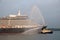 Cruise ship arriving port with tug UK