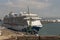 Cruise ship on berth with a background of fuel tanks. Le Havre, France.