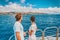 Cruise ship couple on summer Caribbean travel vacation relaxing on boat deck looking at sea. Man and woman tourists on