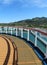 Cruise ship deck and railing with tropical island views in the background