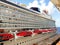 Cruise ship detail, lifeboats and tender boats in large cruise ship. Cruise ship docking in Caribbean pier. Cruise ship balcony.