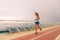 Cruise ship fitness workout run people lifestyle. Woman doing exercise on running track on Caribbean vacation