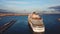 Cruise ship at harbor. Stock. Aerial view of beautiful large white ship at sunset. Colorful landscape with boats in