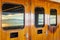 Cruise ship heavy varnished wood exterior doors with windows reflecting the sea.