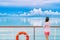 Cruise ship luxury travel woman on deck looking away in Tahiti. Serene still ocean water landscape. Tourism vacation