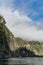 Cruise ship in Milford sound beneath waterfall