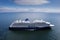 Cruise ship in the ocean, passengers loading n shuttle ferry. Blue cloudy sky. Tourism and travel concept. Elegant voyage by water