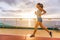 Cruise ship passenger doing morning jogging on deck running tracks with sunrise sunshine. Woman tourist enjoying fitness training