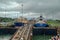 A cruise ship with the passengers on the bow watching ships going through the Panama Canal