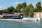 Cruise ship passing through the iron bridge acrossing the Seine river on a sunny day in Paris, France